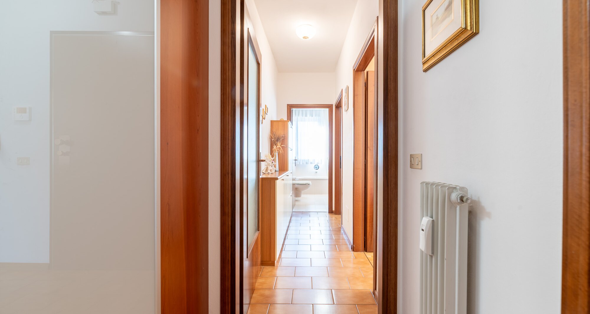 Ampio quadrilocale con terrazza e vista libera, piano alto